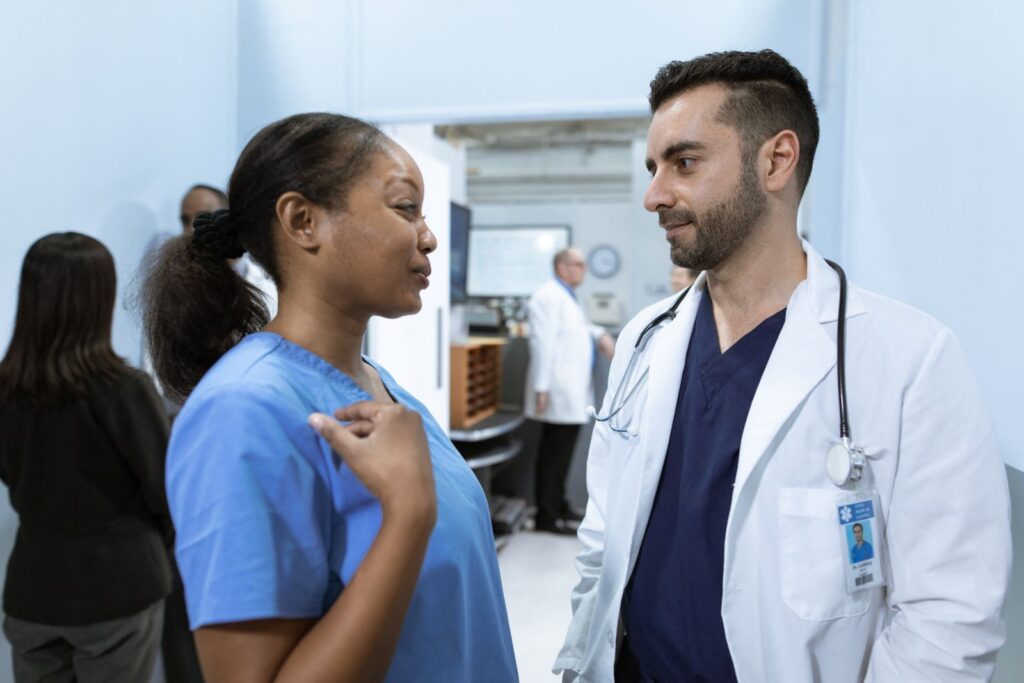 Doctor and nurse talking in a hospital corridor