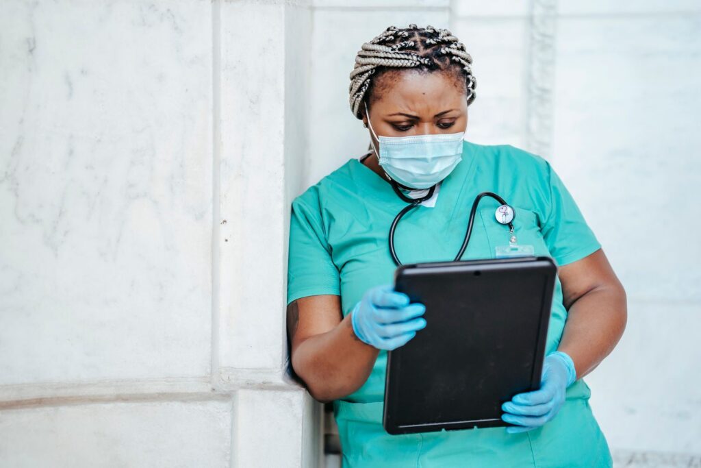 Nurse reviewing records on a tablet