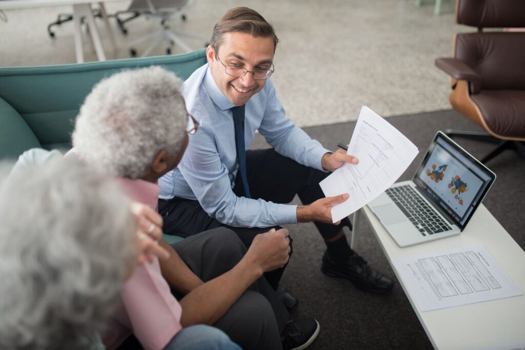 Financial advisor reviewing documents with clients
